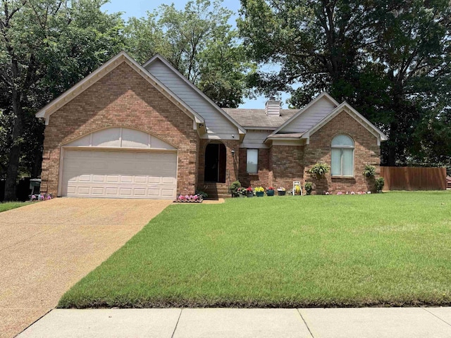 4431 Green Creek Dr, Memphis, TN 38125 - view of front facade with brick siding, concrete driveway, an attached garage, and a chimney