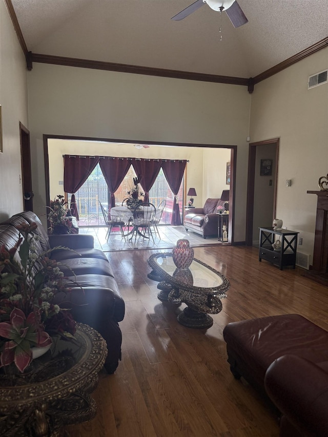 4431 Green Creek Dr, Memphis, TN 38125 - living area with high vaulted ceiling, wood finished floors, a textured ceiling, a ceiling fan, and ornamental molding