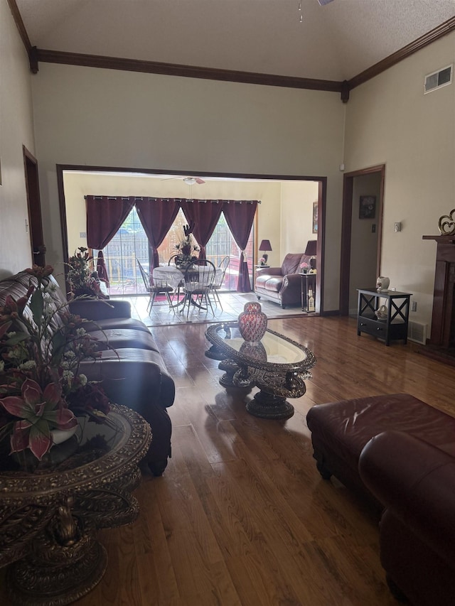 4431 Green Creek Dr, Memphis, TN 38125 - living room with high vaulted ceiling, wood finished floors, crown molding, and a textured ceiling