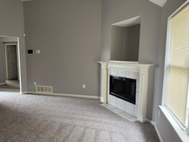 4429 S Cedar Bark Cv, Memphis, TN 38128 - unfurnished living room featuring carpet floors, vaulted ceiling, and a fireplace