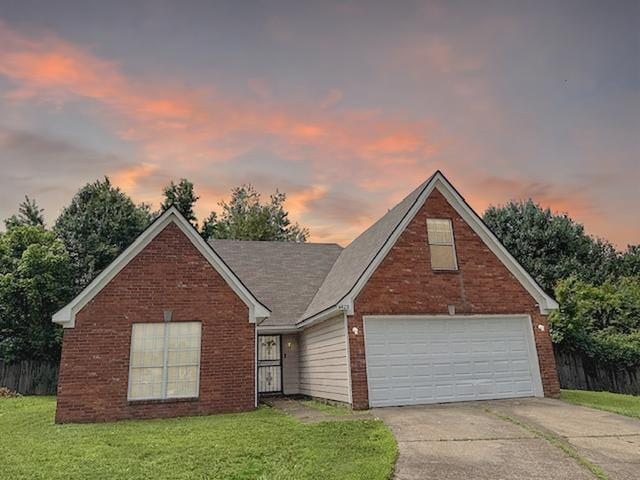 4429 S Cedar Bark Cv, Memphis, TN 38128 - traditional home with a front lawn, concrete driveway, and brick siding