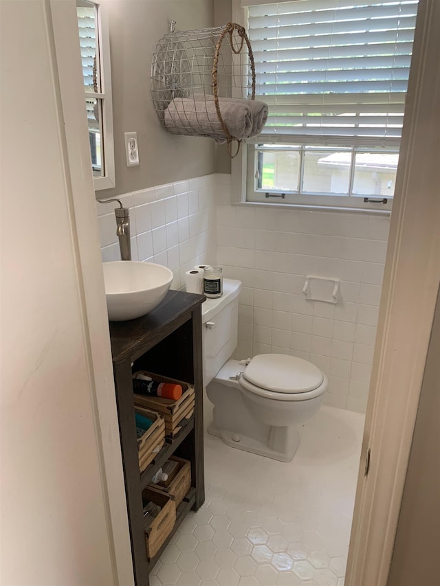 2526 Currywood Cv, Germantown, TN 38138 - half bathroom with tile patterned floors, tile walls, vanity, and a wainscoted wall