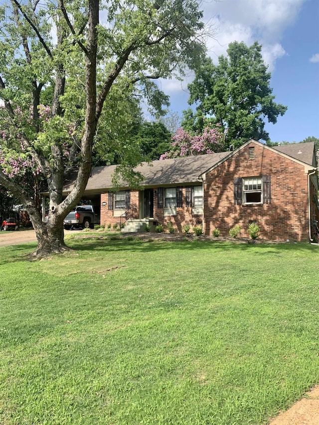 2526 Currywood Cv, Germantown, TN 38138 - ranch-style home with brick siding, a front lawn, a carport, and roof with shingles