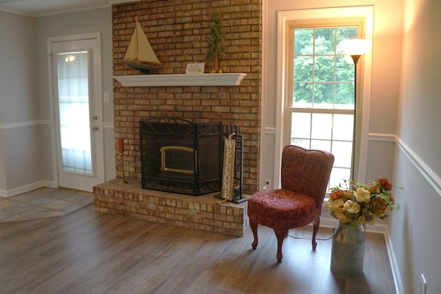 227 Lake Shore Dr, Munford, TN 38058 - living room featuring wood finished floors, a brick fireplace, and ornamental molding