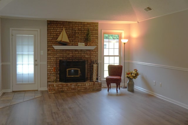 227 Lake Shore Dr, Munford, TN 38058 - living room with wood finished floors, a fireplace, ornamental molding, and lofted ceiling