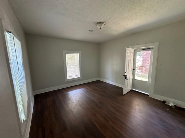 962 Leon Pl, Memphis, TN 38107 - spare room featuring plenty of natural light, dark wood-type flooring, and a textured ceiling