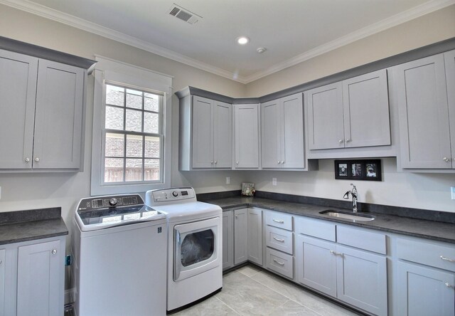 3181 Chapel Woods Cv, Germantown, TN 38139 - laundry area with washing machine and clothes dryer, cabinet space, crown molding, light tile patterned floors, and recessed lighting