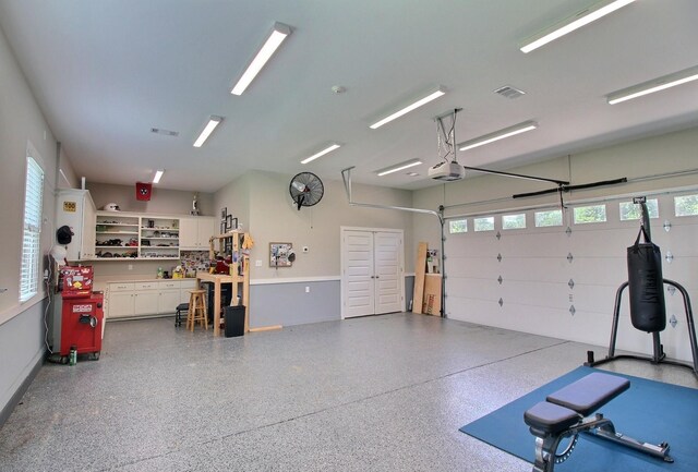 3181 Chapel Woods Cv, Germantown, TN 38139 - garage featuring a garage door opener and a workshop area