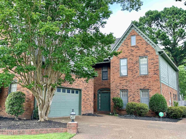 9168 Sycamore Creek Cv, Germantown, TN 38139 - traditional-style house with asphalt driveway, brick siding, and an attached garage