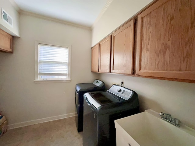 9168 Sycamore Creek Cv, Germantown, TN 38139 - laundry room with cabinet space, crown molding, and washer and clothes dryer