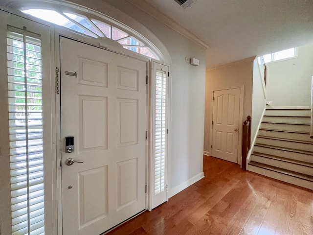 9168 Sycamore Creek Cv, Germantown, TN 38139 - entryway with light wood-type flooring, stairs, and crown molding