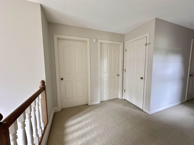 9168 Sycamore Creek Cv, Germantown, TN 38139 - unfurnished bedroom featuring light carpet and a textured ceiling