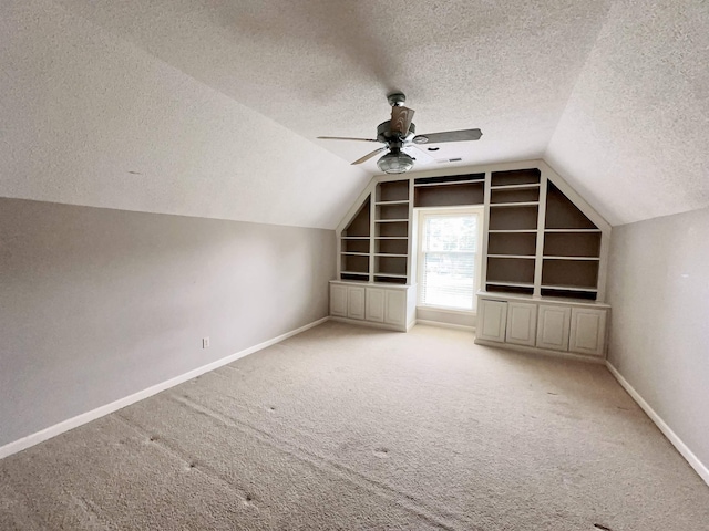9168 Sycamore Creek Cv, Germantown, TN 38139 - additional living space featuring a textured ceiling, vaulted ceiling, carpet floors, a ceiling fan, and built in features
