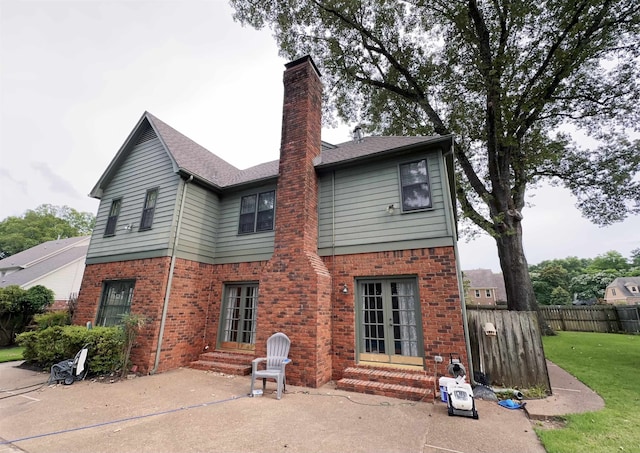 9168 Sycamore Creek Cv, Germantown, TN 38139 - back of house with entry steps, brick siding, a chimney, and a patio area