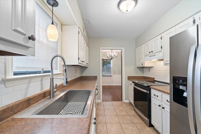 1425 Treehaven Cv, Memphis, TN 38016 - kitchen featuring stainless steel refrigerator with ice dispenser, electric range oven, under cabinet range hood, a textured ceiling, and white cabinets