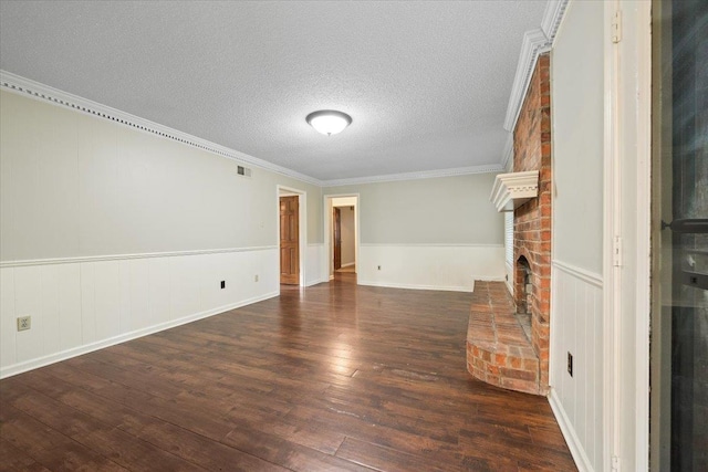 1425 Treehaven Cv, Memphis, TN 38016 - unfurnished living room featuring hardwood / wood-style floors, crown molding, a textured ceiling, a wainscoted wall, and a fireplace