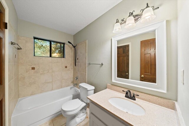 1425 Treehaven Cv, Memphis, TN 38016 - bathroom with tub / shower combination, vanity, a textured ceiling, and tile patterned flooring