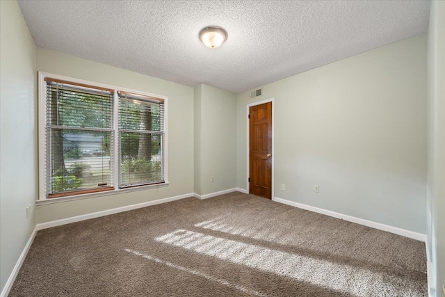 1425 Treehaven Cv, Memphis, TN 38016 - unfurnished room with healthy amount of natural light, carpet flooring, and a textured ceiling