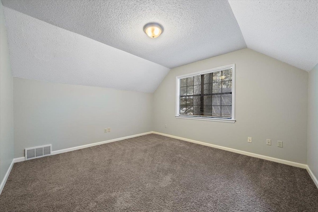 1425 Treehaven Cv, Memphis, TN 38016 - bonus room with lofted ceiling, carpet floors, and a textured ceiling