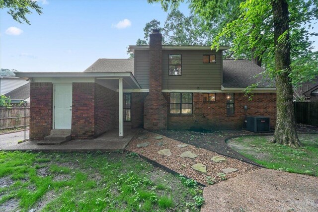 1425 Treehaven Cv, Memphis, TN 38016 - back of house featuring brick siding, a chimney, entry steps, and a patio area