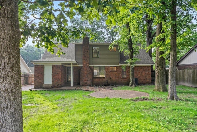 1425 Treehaven Cv, Memphis, TN 38016 - back of property featuring brick siding, a chimney, and roof with shingles