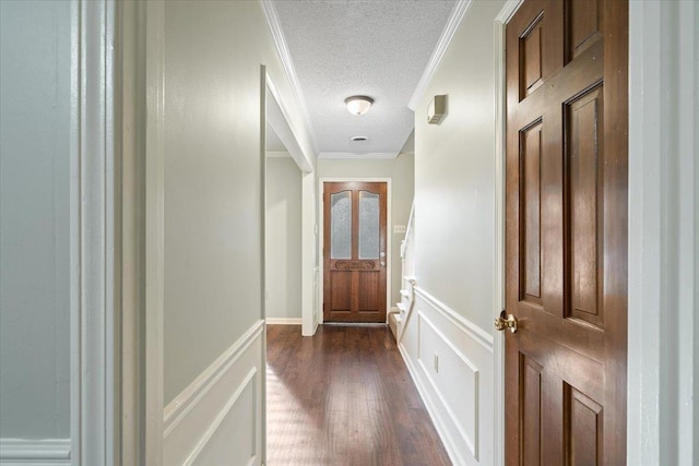 1425 Treehaven Cv, Memphis, TN 38016 - hall with a textured ceiling, dark wood-type flooring, ornamental molding, a decorative wall, and wainscoting