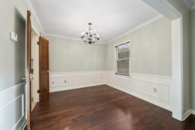 1425 Treehaven Cv, Memphis, TN 38016 - unfurnished dining area featuring a chandelier, ornamental molding, dark wood-style flooring, a wainscoted wall, and a textured ceiling