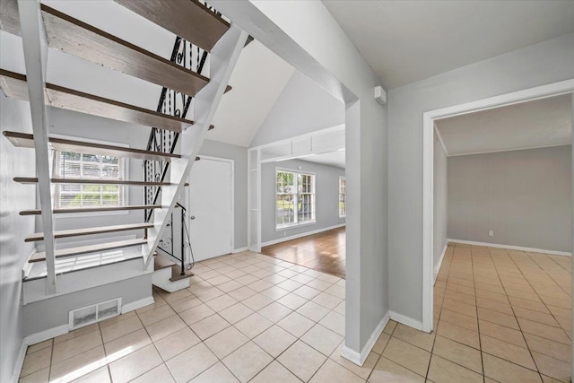 4526 Bogart St, Memphis, TN 38116 - entryway featuring light tile patterned floors, stairway, and vaulted ceiling