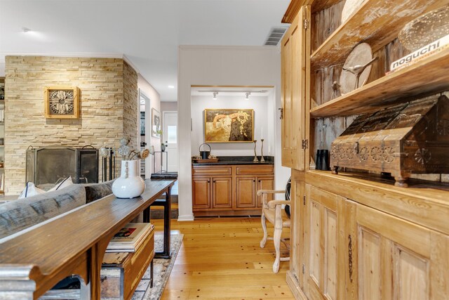 2016 Restington Ln Unit 2016, Memphis, TN 38119 - dining space featuring light wood finished floors, crown molding, and a stone fireplace