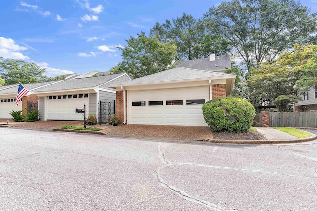 2016 Restington Ln Unit 2016, Memphis, TN 38119 - view of front of property featuring brick siding, a garage, and a chimney