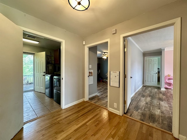 520 Jernigan Dr, Somerville, TN 38068 - hallway featuring wood finished floors, ornamental molding, and washing machine and clothes dryer