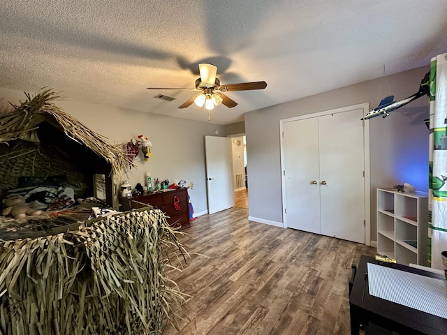 520 Jernigan Dr, Somerville, TN 38068 - bedroom featuring wood finished floors, a ceiling fan, a textured ceiling, and a closet