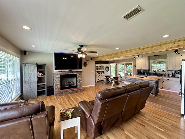 520 Jernigan Dr, Somerville, TN 38068 - living room featuring recessed lighting, light wood-style flooring, a ceiling fan, and a fireplace