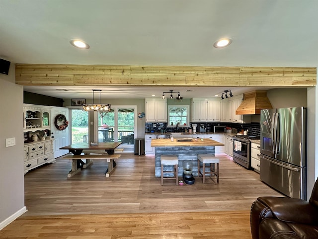 520 Jernigan Dr, Somerville, TN 38068 - kitchen with stainless steel appliances, white cabinets, recessed lighting, decorative backsplash, and a center island