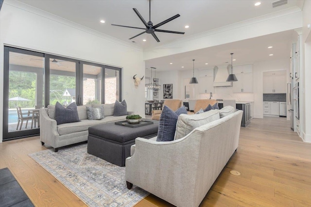 7066 Allelon Cir N, Germantown, TN 38138 - living room with crown molding, healthy amount of natural light, light wood-style flooring, a ceiling fan, and recessed lighting