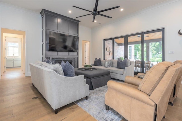 7066 Allelon Cir N, Germantown, TN 38138 - living room with ornamental molding, a ceiling fan, healthy amount of natural light, light wood-type flooring, and a large fireplace