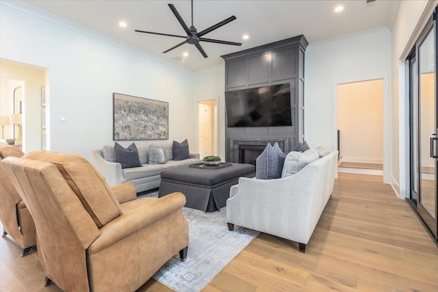7066 Allelon Cir N, Germantown, TN 38138 - living area with a ceiling fan, light wood-style floors, crown molding, recessed lighting, and a large fireplace