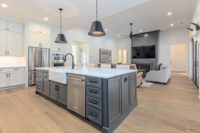 7066 Allelon Cir N, Germantown, TN 38138 - kitchen featuring appliances with stainless steel finishes, gray cabinets, light wood-style flooring, ceiling fan, and white cabinets