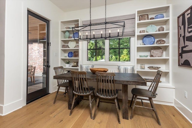 7066 Allelon Cir N, Germantown, TN 38138 - dining space with light wood-type flooring, a chandelier, and built in shelves