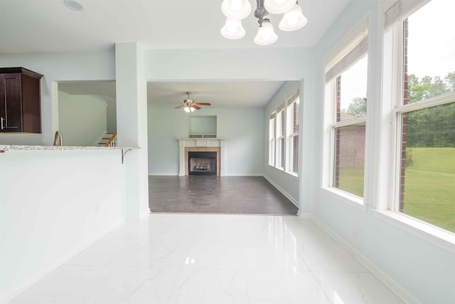 4560 Model Cv, Bartlett, TN 38002 - unfurnished living room featuring ceiling fan, a tiled fireplace, a chandelier, and light marble finish floors