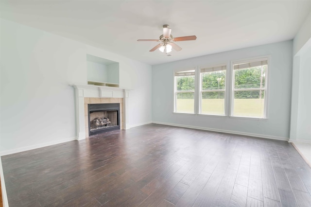 4560 Model Cv, Bartlett, TN 38002 - unfurnished living room featuring ceiling fan, a tiled fireplace, and wood finished floors