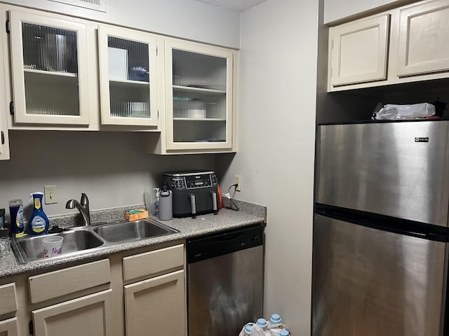 109 N Main St Unit 1202, Memphis, TN 38103 - kitchen featuring appliances with stainless steel finishes, glass insert cabinets, and light countertops