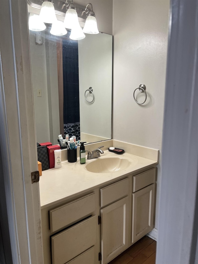 109 N Main St Unit 1202, Memphis, TN 38103 - bathroom featuring vanity, wood finished floors, and a chandelier