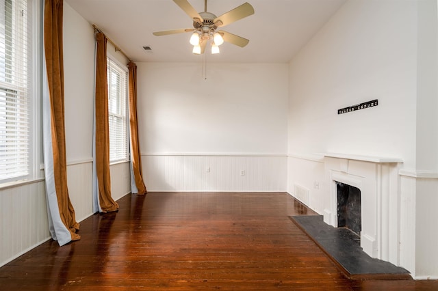 378 Mulberry St, Memphis, TN 38103 - unfurnished living room with a wainscoted wall, wood-type flooring, ceiling fan, and a fireplace