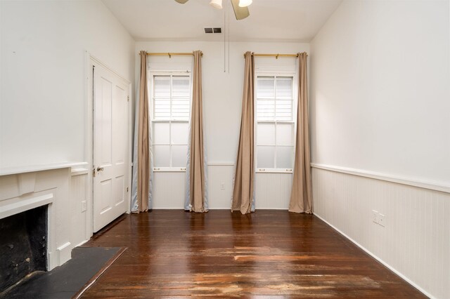 378 Mulberry St, Memphis, TN 38103 - unfurnished living room featuring plenty of natural light, wood-type flooring, a ceiling fan, a fireplace, and wainscoting
