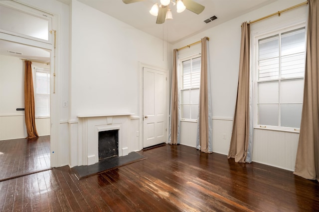 378 Mulberry St, Memphis, TN 38103 - unfurnished living room featuring ceiling fan, hardwood / wood-style floors, a fireplace with raised hearth, and healthy amount of natural light