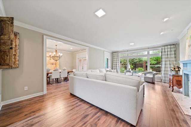 4654 Hemlock Ln, Memphis, TN 38117 - living room featuring ornamental molding, wood finished floors, a chandelier, a fireplace, and recessed lighting