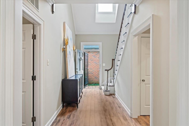 4654 Hemlock Ln, Memphis, TN 38117 - hallway with stairs, light wood-style floors, crown molding, and healthy amount of natural light