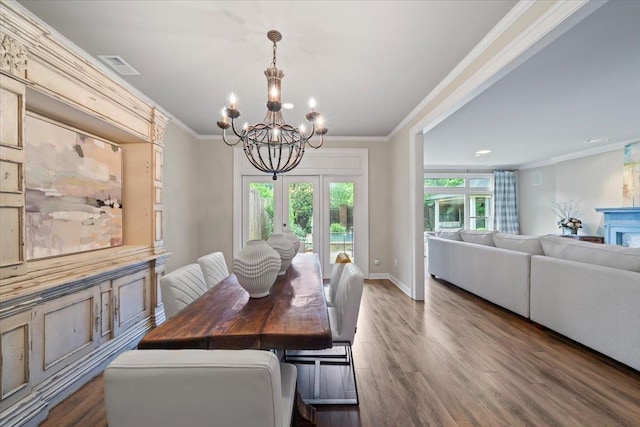 4654 Hemlock Ln, Memphis, TN 38117 - dining area with a chandelier, dark wood finished floors, ornamental molding, and recessed lighting
