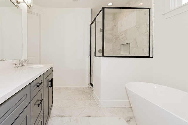 3615 Kearney Ave, Memphis, TN 38111 - bathroom with vanity, a soaking tub, a shower stall, marble look tiles, and recessed lighting